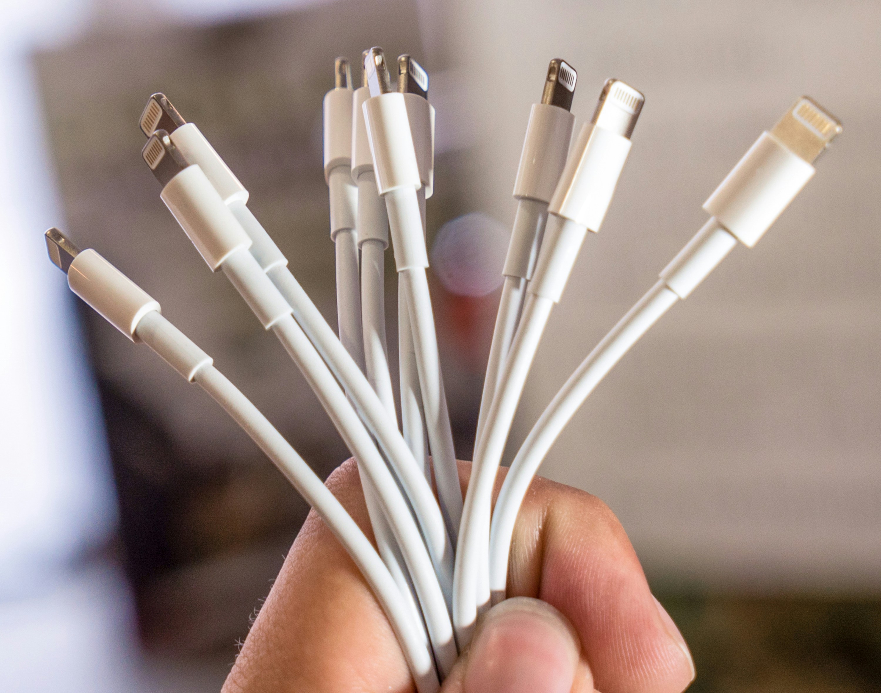 A group of cables held together by a hand